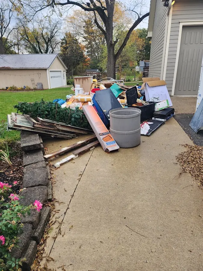 Dumpster being loaded with debris for Residential Dumpster Rental in Flowery Branch